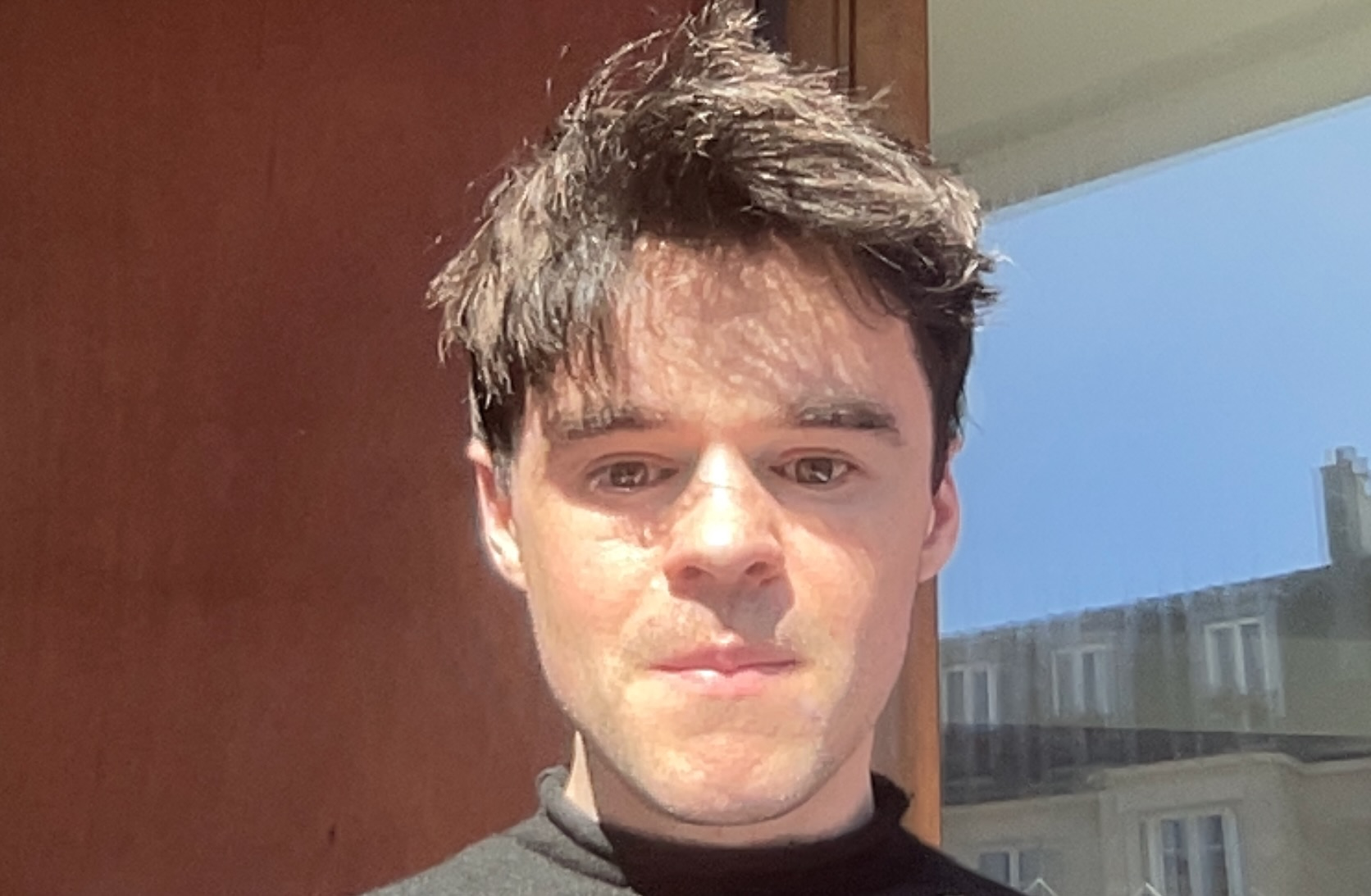 Michael Phoenix a man with brown hair and green eyes, in a black jumper